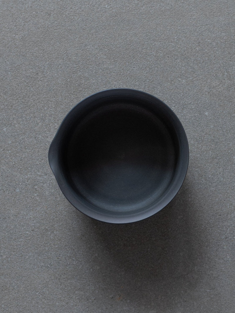 Top view of a black ceramic Match bowl on grey background